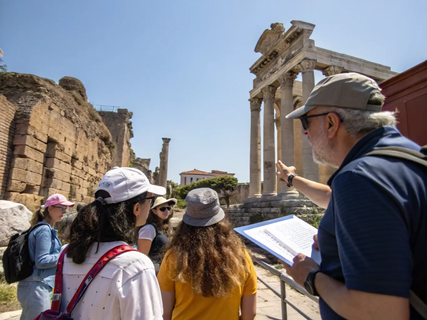 A photograph of a guided tour through a historical site, with participants listening attentively to a knowledgeable guide. The backdrop features ancient architecture and scenic landscapes, highlighting the region's rich historical narrative.